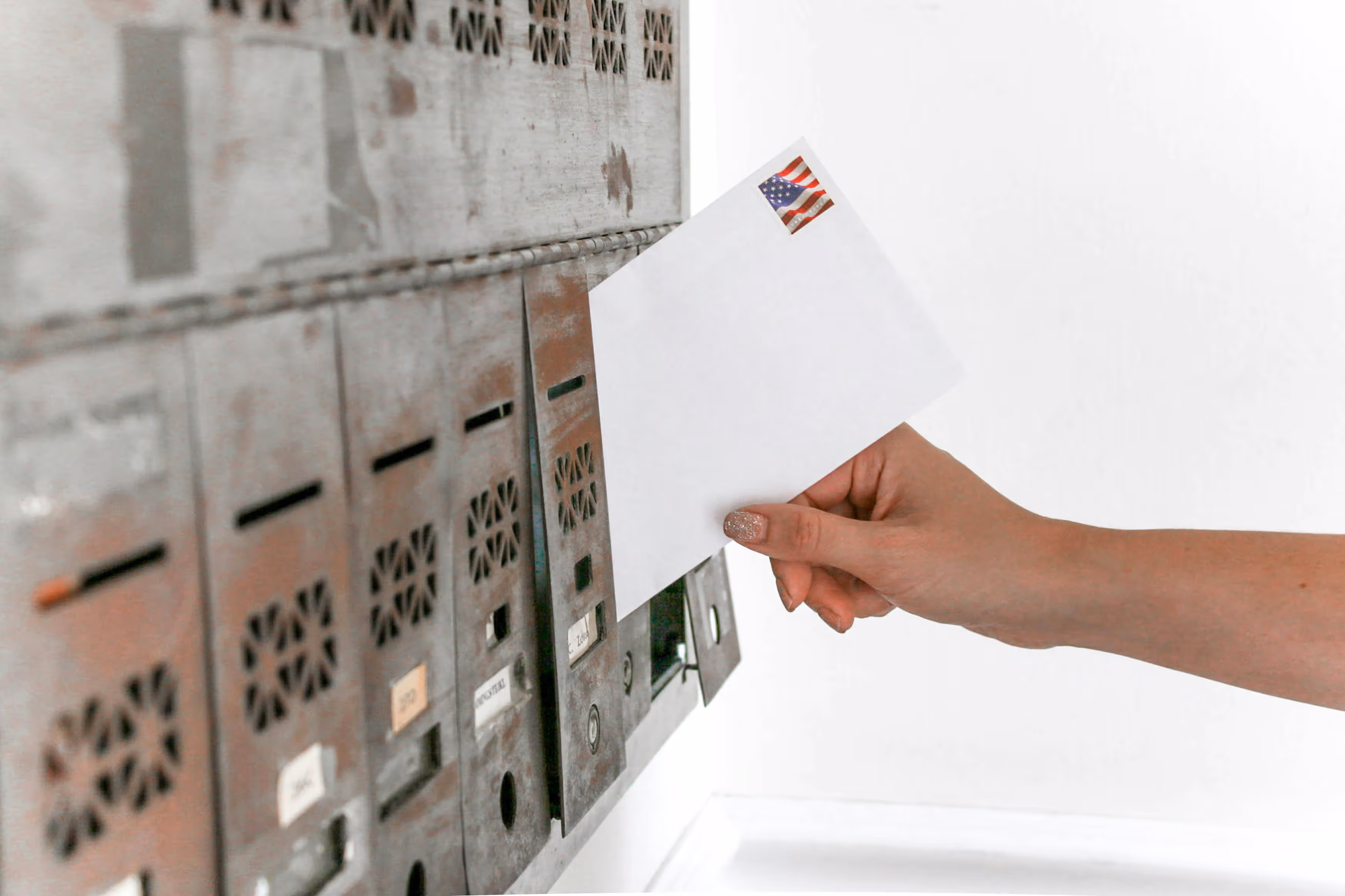 Person holding a ballot envelope